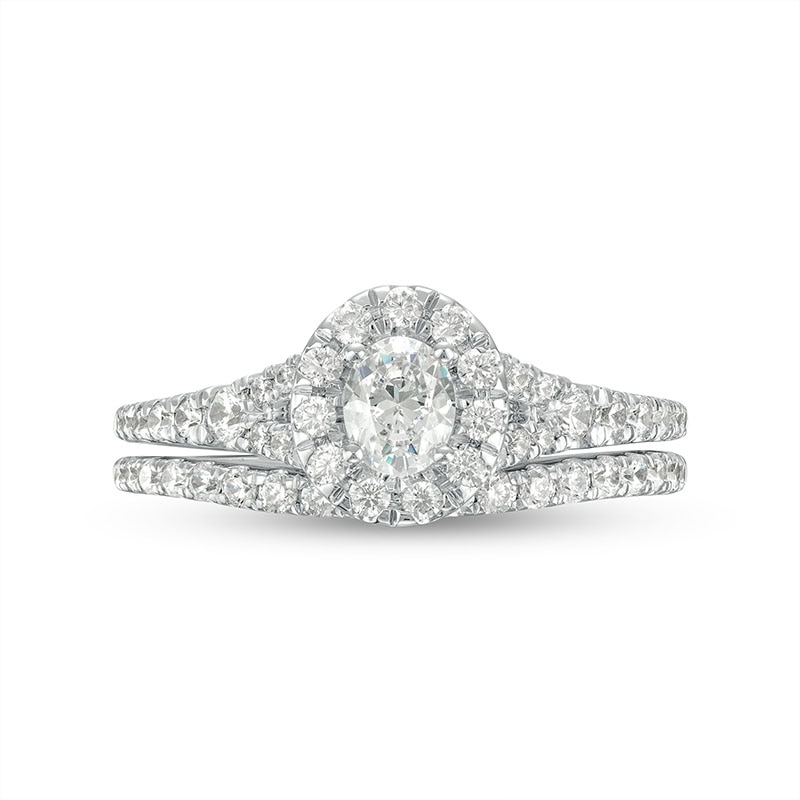 Previously Owned - 0.95 CT. T.W. Oval Diamond Frame Bridal Set in 14K White Gold (I/I1)