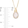 Previously Owned - Oval Opal and 0.09 CT. T.W. Diamond Frame Pendant in 10K Gold