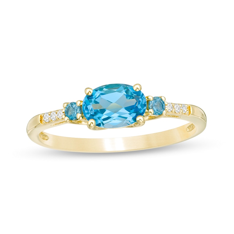 Previously Owned - Sideways Oval Blue Topaz and Diamond Accent Ring in 10K Gold