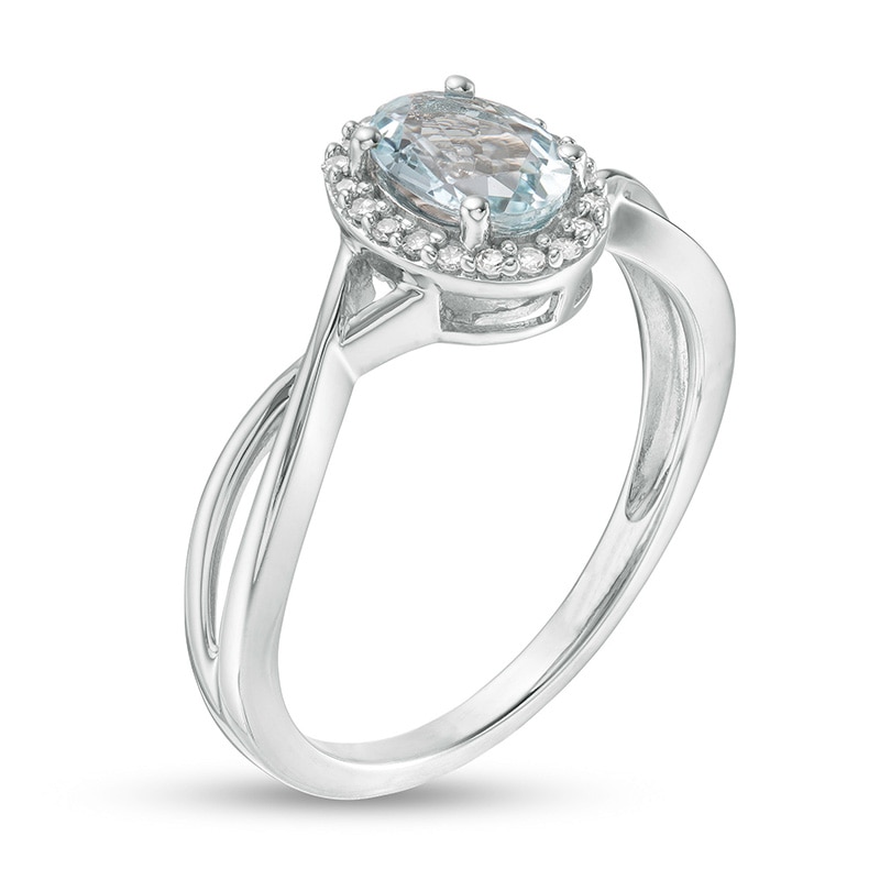 Previously Owned - Oval Aquamarine and 0.08 CT. T.W. Diamond Frame Twist Shank Ring in 10K White Gold