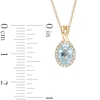 Previously Owned - Oval Swiss Blue Topaz and 0.08 CT. T.W. Diamond Frame Twisted Split Bail Pendant in 10K Gold