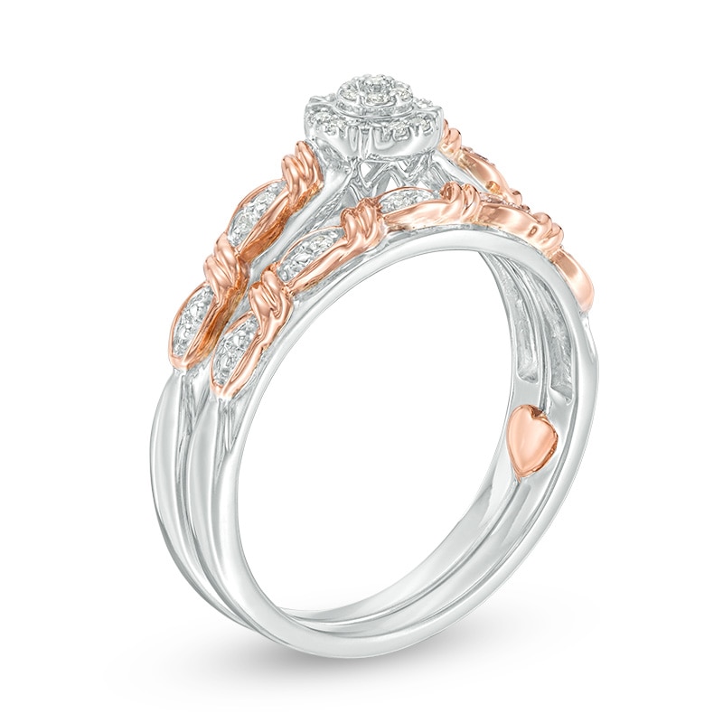 Previously Owned - 0.10 CT. T.W. Composite Diamond Frame Twist Ribbon Interlocking Bridal Set in 10K Two-Tone Gold