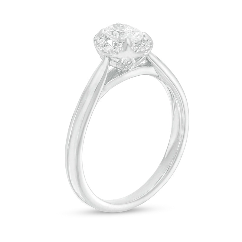 Previously Owned - 0.62 CT. T.W. Oval Diamond Frame Engagement Ring in 14K White Gold (I/I2)