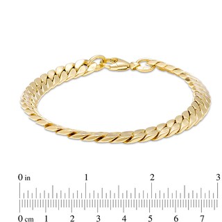 Previously Owned - Italian Gold 7.0mm Flat Curb Chain Link Bracelet in 18K Gold - 7.26"