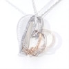 0.065 CT. T.W. Diamond Infinity Knot Tilted Heart Pendant in Sterling Silver and 10K Rose Gold