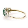 Oval Emerald and 0.04 CT. T.W. Diamond Three Stone Frame Ring in 10K Gold